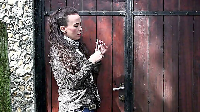Irresistibly sexy Sylvia has a cigarette outdoors