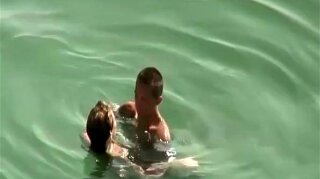 Small tits and puffy nipples nudist woman fucking in the water with her man.