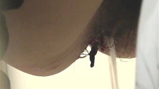 A fat and dirty pussy of the amateur female is spied in close up when pissing in toilet. You can also notice red something pouring out, so it becomes clear the woman must have her periods
