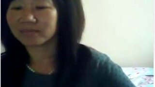 Cute mature Asian woman teases her cute boobs to people she is chatting with
