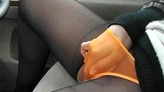 Watch a sexy Asian babe drive and get off in public. She can't resist playing with her toy in her black stockings until she cums.