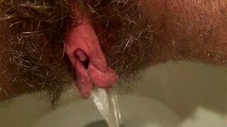 Experience the ultimate pleasure as you delve into the enticing world of a hairy goddess exploring her wildest desires up close. Don't miss the moment of pure bliss as she quenches her thirst with uninhibited pissing action.