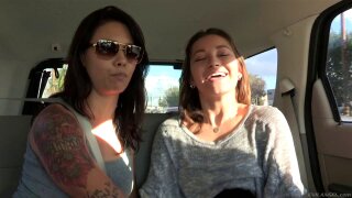 A pair of babes pull off the road and fuck next to the car